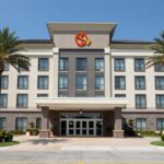 Hotel near Komodo Airport runway with palm trees.