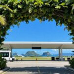 Komodo Airport terminal with tropical foliage and islands.
